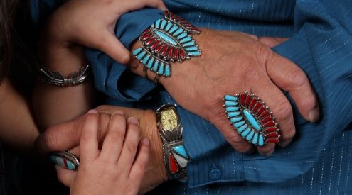 Hands of child and adult intertwined