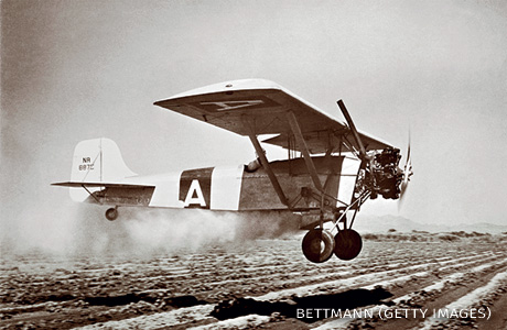 An image of an airplane dusting a field with D.D.T.