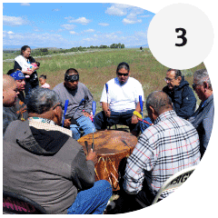 Group of Indigenous people participating in drum circle